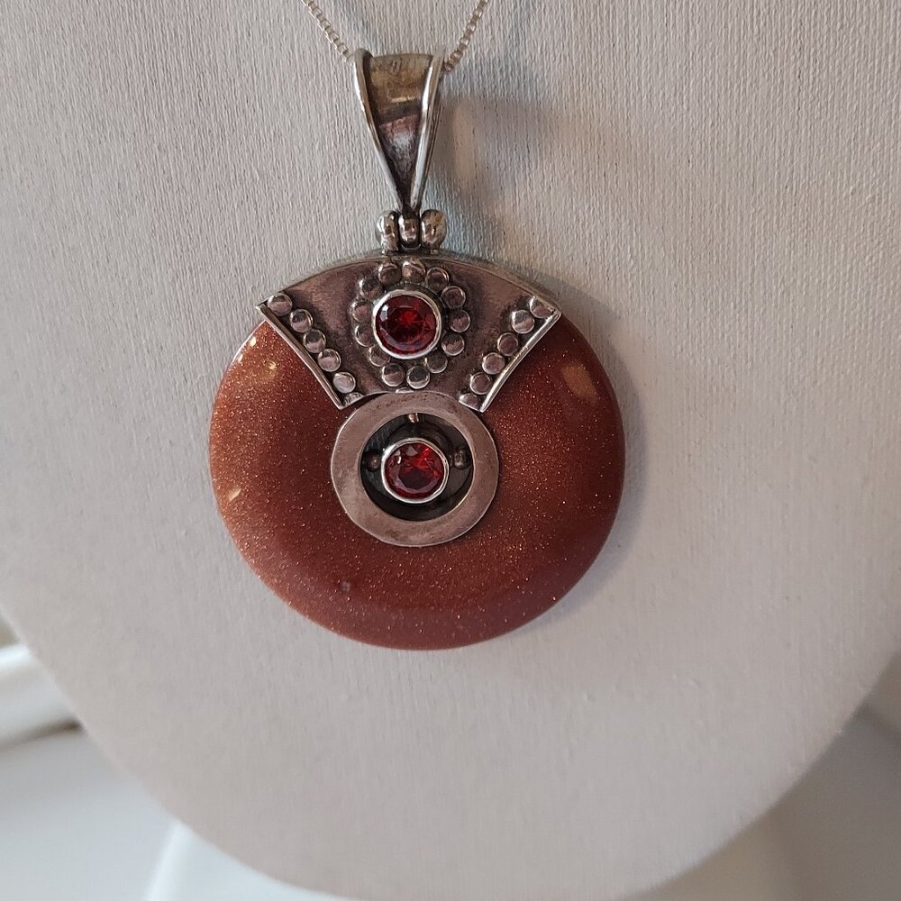 Pendant of Goldstone in Sterling Silver with Garnets